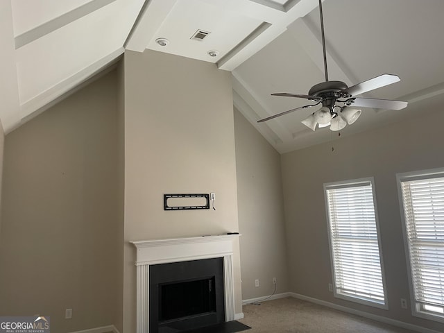 unfurnished living room featuring a ceiling fan, carpet, baseboards, a fireplace with flush hearth, and vaulted ceiling