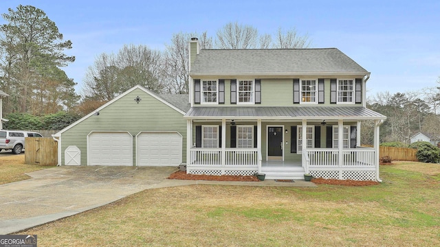 view of front of house with a chimney, driveway, a front lawn, a porch, and an attached garage