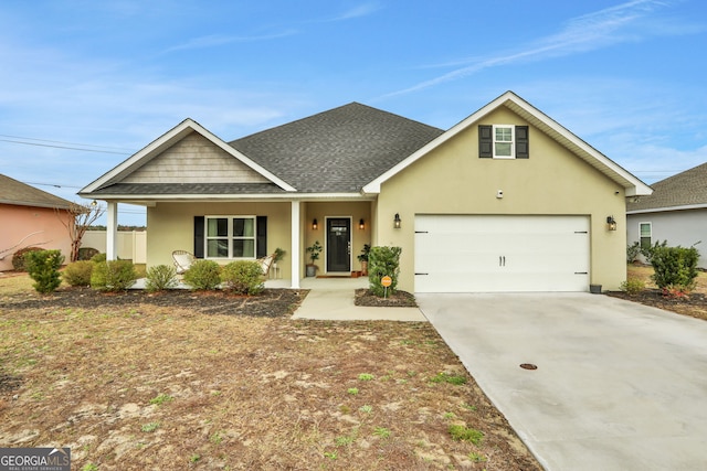 view of front of home featuring driveway, a shingled roof, an attached garage, a porch, and stucco siding