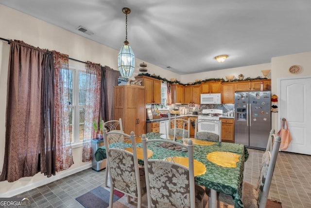 dining area with visible vents, baseboards, and tile patterned floors