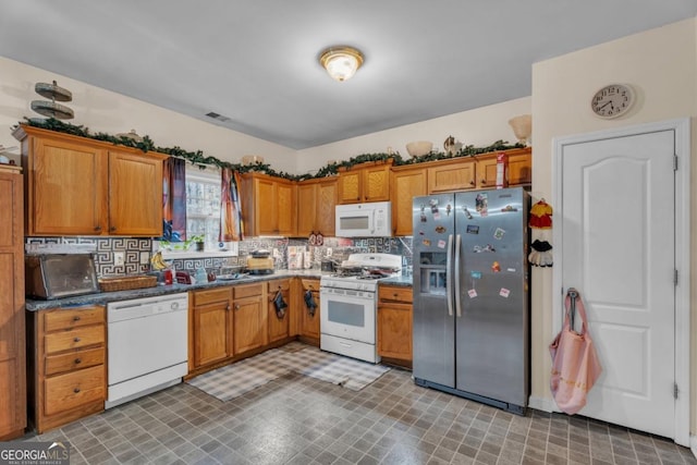 kitchen featuring white appliances, brown cabinets, backsplash, and tile patterned floors