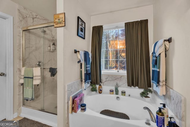 full bath featuring a marble finish shower and a bath