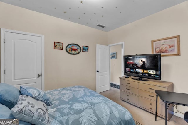 carpeted bedroom featuring visible vents