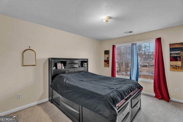 bedroom featuring baseboards, visible vents, and light colored carpet