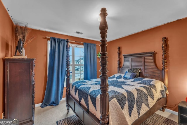 bedroom featuring visible vents, baseboards, and light colored carpet