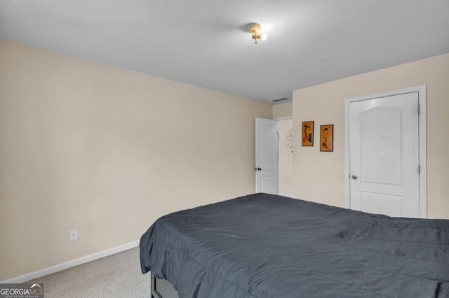 bedroom with carpet, visible vents, and baseboards