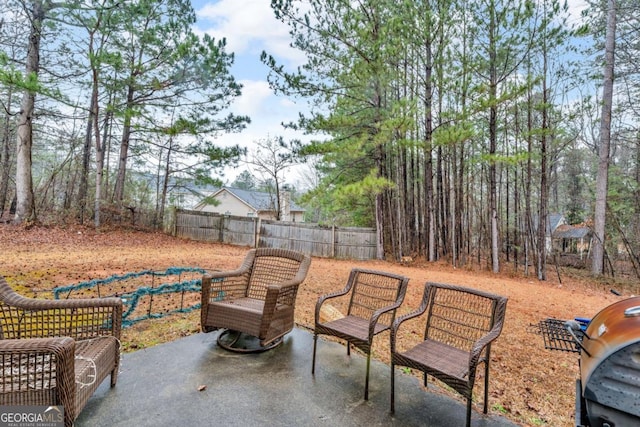 view of patio / terrace featuring grilling area and fence