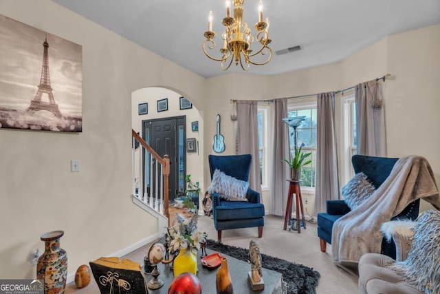 sitting room featuring arched walkways, a notable chandelier, visible vents, stairway, and carpet