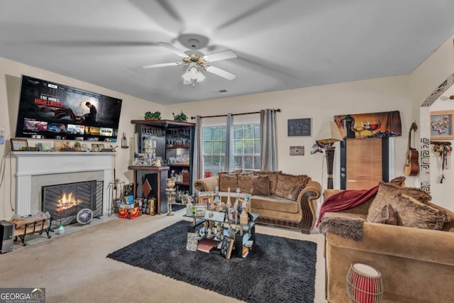 living area featuring carpet, a fireplace with flush hearth, visible vents, and ceiling fan