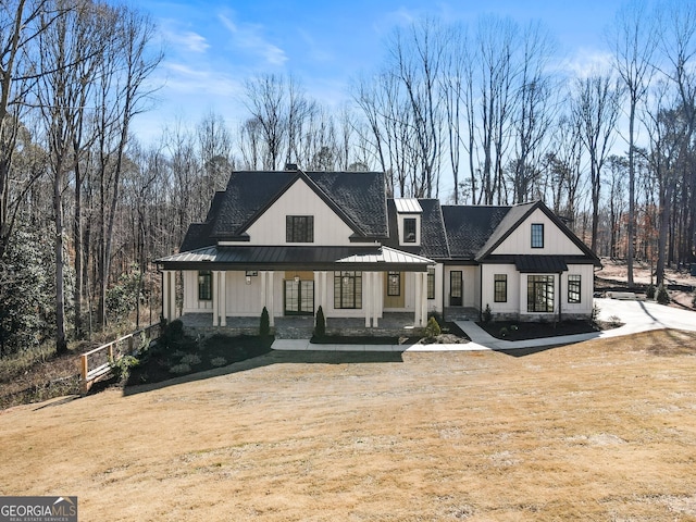 rear view of property featuring covered porch, metal roof, and a standing seam roof