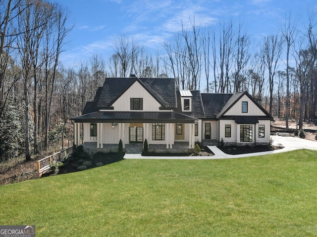 modern farmhouse featuring a standing seam roof, metal roof, a front lawn, and covered porch