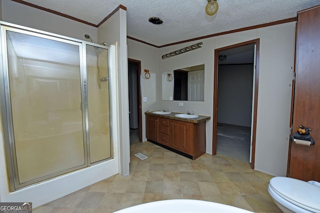 bathroom featuring vanity, a textured ceiling, visible vents, crown molding, and a shower stall
