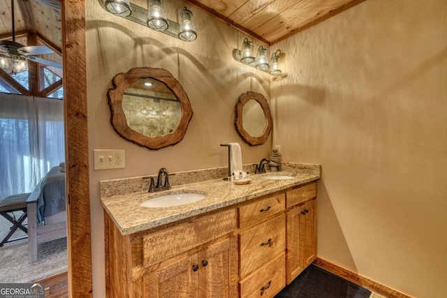 bathroom featuring double vanity, wooden ceiling, a ceiling fan, and a sink