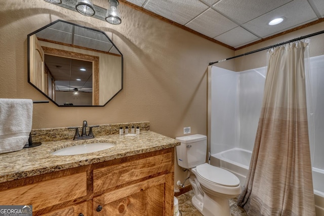 full bath with a textured wall, toilet, shower / tub combo with curtain, vanity, and a paneled ceiling