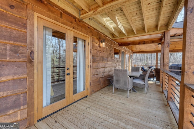 wooden deck with french doors and outdoor dining space