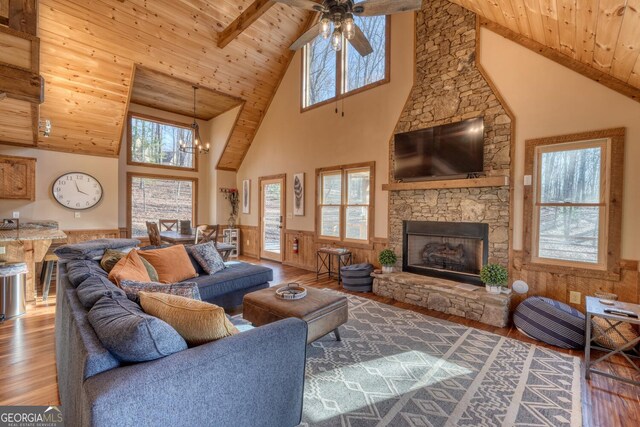 living room featuring plenty of natural light, wood ceiling, and dark wood-style floors