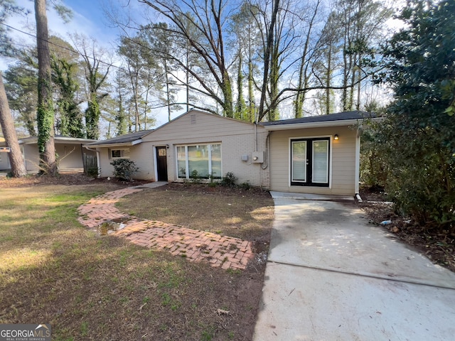 view of front of house with a front yard and brick siding