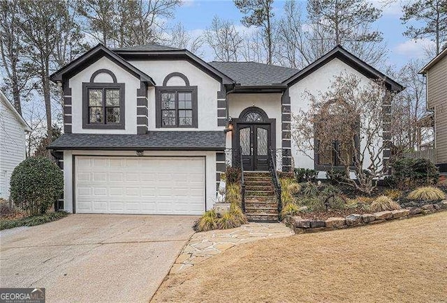 view of front facade featuring french doors, driveway, roof with shingles, stucco siding, and an attached garage