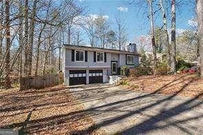 split foyer home featuring driveway and a garage