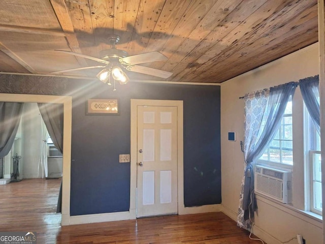 foyer entrance with a ceiling fan, wood ceiling, baseboards, and wood finished floors