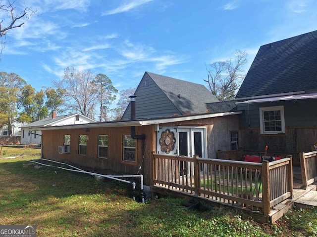 back of house featuring a shingled roof, a lawn, cooling unit, and a wooden deck