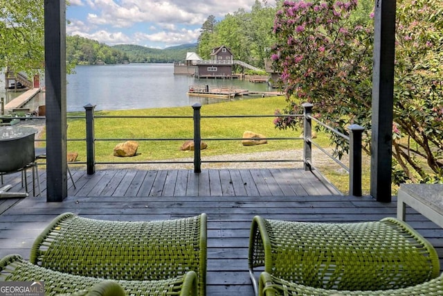 deck with a dock and a water view