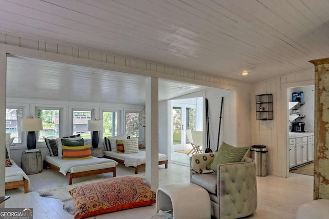 sunroom with vaulted ceiling and wood ceiling