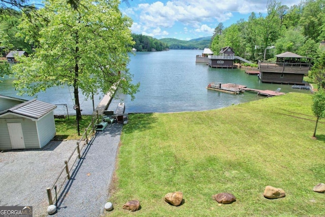 dock area featuring a water view and a yard