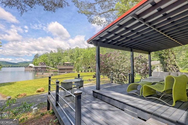 wooden terrace featuring a yard and a water view