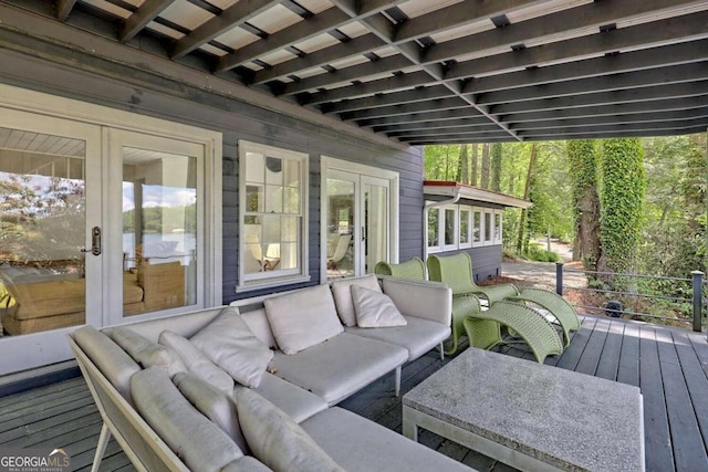 wooden terrace with an outdoor hangout area and french doors