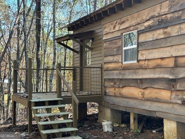 view of side of home featuring stairs