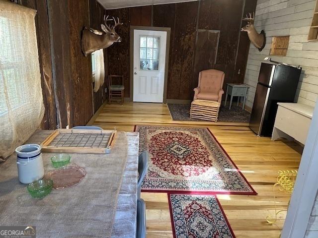 foyer with wood walls and wood finished floors