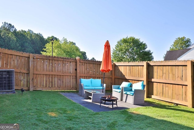 view of yard featuring a patio area, a fenced backyard, central AC unit, and an outdoor living space with a fire pit