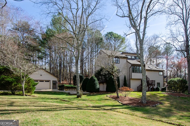 exterior space featuring a garage, stairway, and an outdoor structure