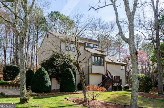 view of front facade featuring a front yard and stairs