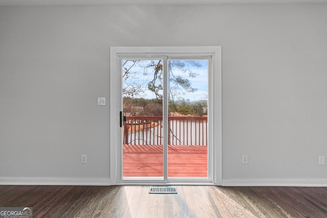 entryway featuring wood finished floors, visible vents, and baseboards