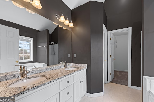 full bathroom with double vanity, a garden tub, walk in shower, and a sink