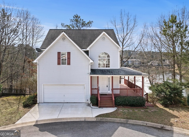 traditional-style home with a garage, concrete driveway, a porch, and a shingled roof