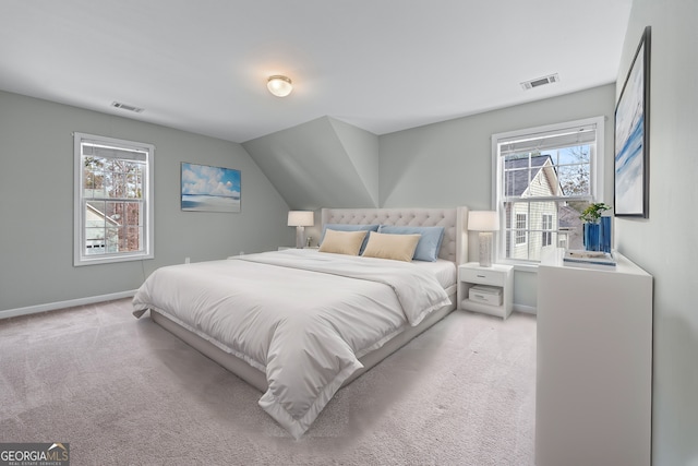 bedroom with light carpet, multiple windows, and visible vents