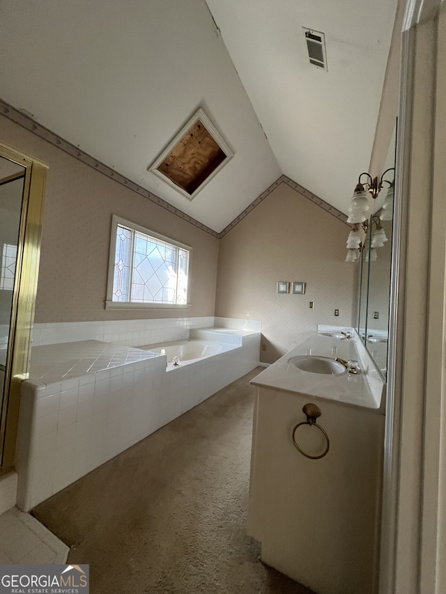 full bath with a garden tub, a sink, visible vents, vaulted ceiling, and carpet