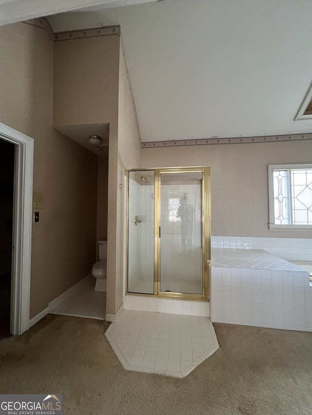 bathroom with toilet, a stall shower, and a bath