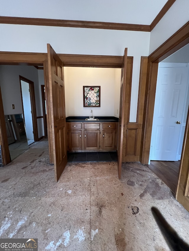 corridor featuring ornamental molding and a sink