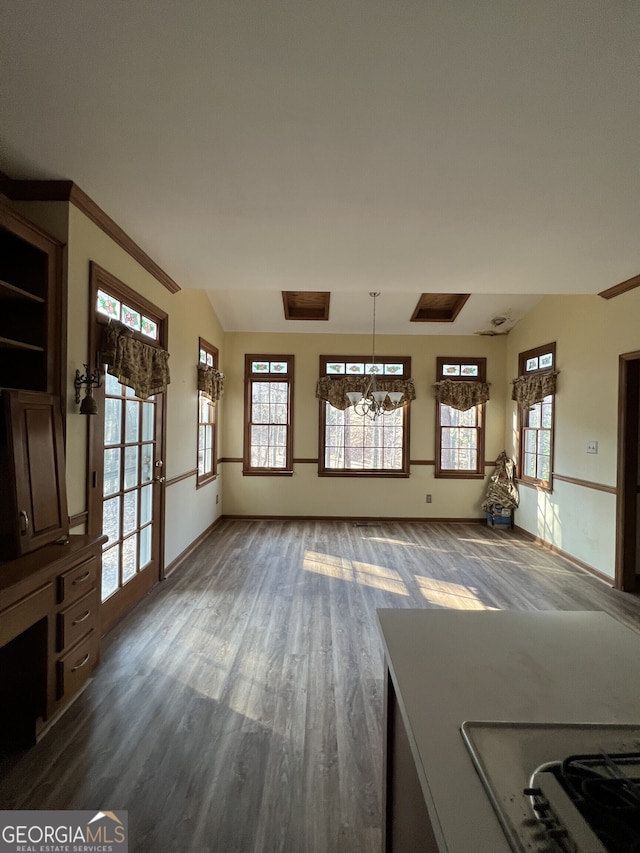 unfurnished living room with dark wood-style floors, vaulted ceiling, and baseboards