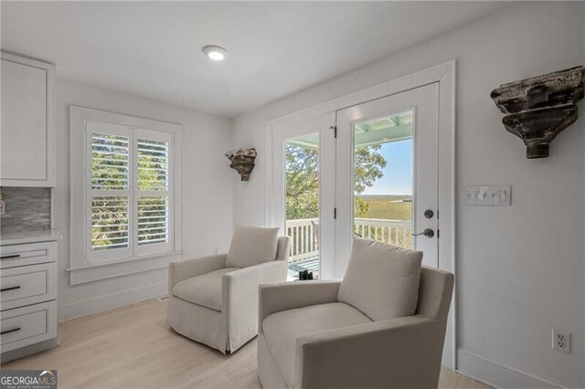 sitting room with light wood-style flooring and baseboards