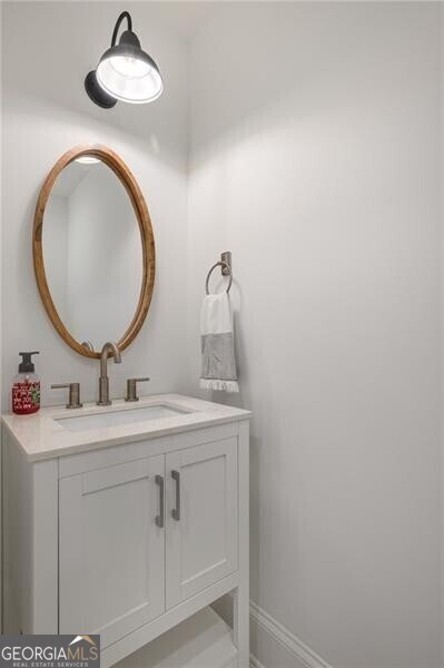 bathroom with vanity and baseboards