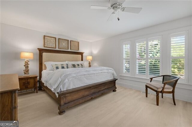 bedroom with ceiling fan and light wood-style floors