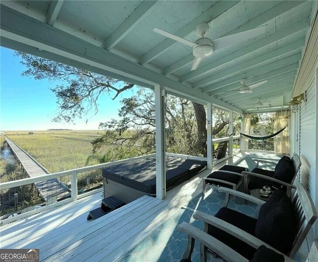 exterior space with ceiling fan, a covered hot tub, and a rural view