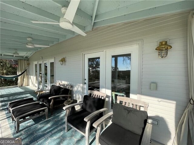 wooden deck featuring a ceiling fan and french doors