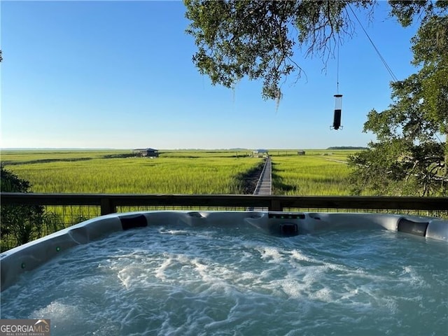 exterior space featuring a rural view and a hot tub