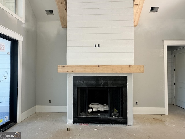 interior details featuring a fireplace, baseboards, and beamed ceiling